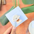 Cute white puppy resin hair clip with pink cheeks on a light blue display card - Brown Scarf Puppy Side Clip