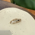Detail of an oval acetate hair clip with marble texture resting on a ceramic dish - Acetate Gold Label BB Clip / Brown Pattern