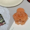 Detailed macro view of peach-colored resin rose hair claw clip for elegant hairstyles - Sandalwood Orange Shimmer Rose Hair Claw