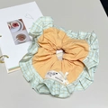 Detail of a large checkered scrunchie with ruffled edges, pearl accent and ribbon bow - Yellow and Cyan Plaid Scrunchie