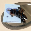 Minimalist acetate hair claw clip with brown tortoiseshell pattern on a metal tray - Square Edge Claw Clip / Clear Colorful Tortoise Shell