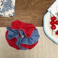 Detail of red polka dot and denim blue ruffled scrunchie on a rustic wooden table - Red White Small Polka Dot Denim Blue Double Layer Scrunchie