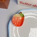 Close-up of marble pattern acetate peach claw clip with green leaf and PEACH text logo - Peach