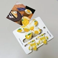 Close-up of lemon pattern hair clip set with floral and fruit motifs on packaging - Yellow Orange Flower Set