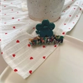 Detailed view of dark green acetate flower hair claw with colorful marble floral pattern - Approx 6cm / Blue Green Flower - Green Multi-color
