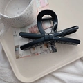 Macro detail of glossy black bow hair claw clip with strong metal spring mechanism - 13.5cm / Glossy Black (X Bow)