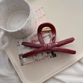 Detail of dark red bow hair claw clip with golden spring on a ceramic tray - 13.5cm / Anchora Red (X Bow)