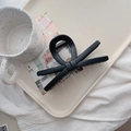 Close-up of a matte black bow hair claw clip displayed on a minimalist white tray - 13.5cm / Matte Black (X Bow)