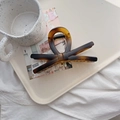 Detail of elegant tortoiseshell bow hair claw clip on a stylish cream jewelry tray - Matte French X-Bow - Butterfly Clip (13.5cm)