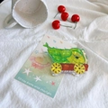 Detail of creative green cauliflower shaped hair claw clip made of acetic acid on white fabric - Corn Cart
