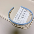 Detailed view of candy color hairbands with anti-slip teeth on a beige display tray - Sky Blue + Off-White