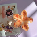 Detail of orange floral Halloween hair claw featuring pumpkin, ghost and bat patterns - Orange Base Pumpkin Ghost Bat Flower Claw
