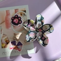 Detail of flower-shaped hair claw clip with colorful sugar skull patterns for Halloween - Black Base Colorful Skeleton Flower Claw
