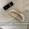 Detail of large acetate hair claw with cream marble texture on floral fabric background - Acetate Sheet / Creamy White Texture