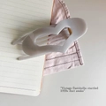 Detail shot of heart-shaped hair claw clip in muted lavender with gold spring - Cement Grey