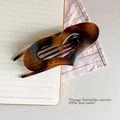 Detail view of heart-shaped hair claw clip with vintage tortoiseshell resin texture - Matte French Brown