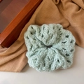 Detail of light green hollow-out crochet scrunchie with soft knit texture on warm backdrop - Sea Salt Green (Hollow Flower Woolen)