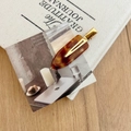 Detail of tortoiseshell resin hair clip with gold metal clasp on canvas background - Brown Leopard Print
