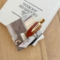 Detail of tortoise shell acetate hair clip with golden metal clip and Creation France mark - Americano