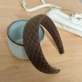 Close-up of brown plaid wool headband with sponge padding on a textured ceramic cup - Coffee Brown Fine Plaid