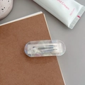 Close-up of translucent acetate hair clip with silver spring detail on a notebook - Iridescent Mermaid
