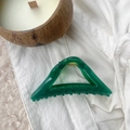 Detailed view of an emerald green hollow triangular hair claw clip with golden spring - Emerald Green