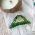 Detailed macro shot of a 12cm transparent green triangular shark clip on white fabric - Transparent Green