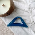 Detail view of large dark blue triangular hair claw clip on lace and rug - Navy Blue
