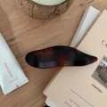 Close-up of tortoise shell resin hair claw clip with mottled amber texture on wood - 11.5CM / Matte French Brown