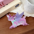 Detail of pink marble textured acetate reindeer hair claw clip on a vintage wooden table - Pink Purple Winged Flying Deer
