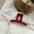 Detailed view of 5cm burgundy glossy hair claw clip on white lace fabric with candle - 5.2cm / Ancorra Red