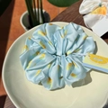 Light blue satin scrunchie with lemon patterns and soft ruffled texture design - Sliced Lemon Sea Salt Blue Scrunchie