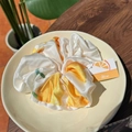 Elegant satin scrunchie with yellow lemon print pattern on cream white fabric - Orange Juice Moonlight White Scrunchie