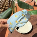 Sky blue knot headband with yellow shell patterns and smooth fabric texture - Lemon Slices High Top Headband