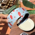 Light blue dopamine hairband with tomato pattern print for women held in hand - Tomato Blue Wide Headband