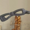 Elegant dark grey bow-shaped banana clip hair accessory with a smooth resin finish - Stone Grey