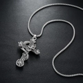Gothic silver snake and skull cross necklace pendant on black textured background - Snake Pattern Skull Cross Style