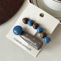 Two-piece heart beaded hair clip set with brown and blue accents on brand display card - Heart Polka Dot Style