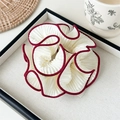 Macro detail of pleated oversized scrunchie hair tie with contrast red edge on tray - Pleated Scrunchie / Burgundy