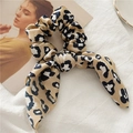 Detail of elegant leopard print satin scrunchie with bow on textured fabric background - Leopard Print Knot Khaki