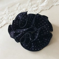 Detailed close-up of a navy blue polka dot scrunchie with white lace on beige fabric - Small Polka Dot Navy Blue