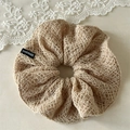 Detail view of beige handmade crochet hair scrunchie with intricate knitted pattern - Brown