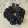Close-up of black and white striped scrunchie with handmade label and display card - Black Stripe