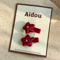 Close-up of red velvet star hair clips with pearl beads on an elegant display card - Red Hair Clip