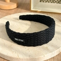 Knitted wide black headband with refined woven texture and True Fitted label - Black