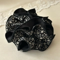 Floral scrunchie in black and white pattern with pleated fabric and ruffled design - Black