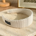 Elegant beige knitted headband for women with True Fitted patch and woven texture - Beige