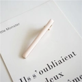 Detail of a minimalist pink rectangular hair clip on a decorative card with golden metal clip - Light Pink