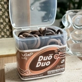 Close-up of brown elastic hair ties for kids in a transparent square storage box - Brown