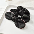 Detail of black satin bow scrunchie featuring elegant red white and blue ribbon edges - Black